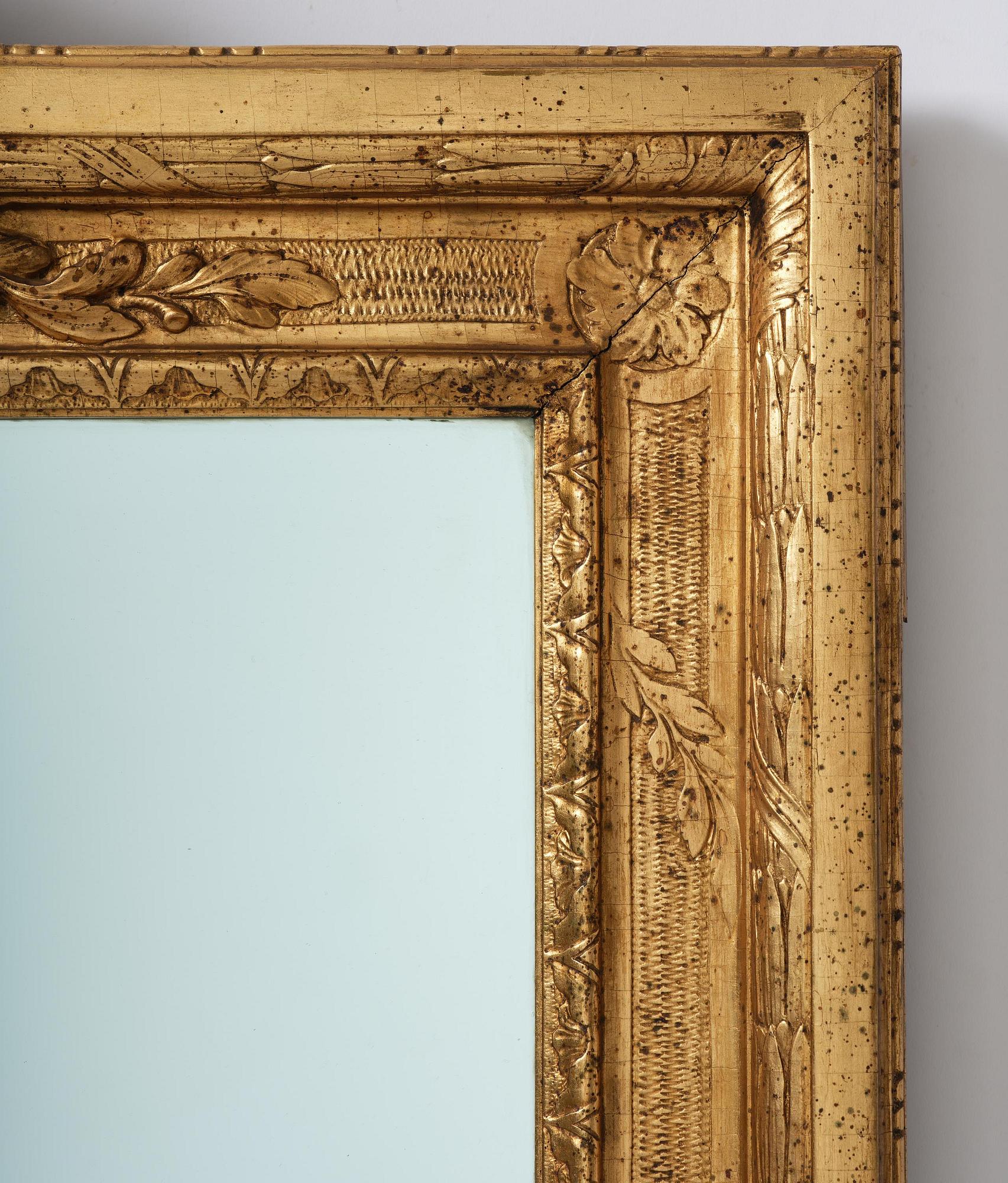 A Gustavian giltwood frame with mirror glass, late 18th century.