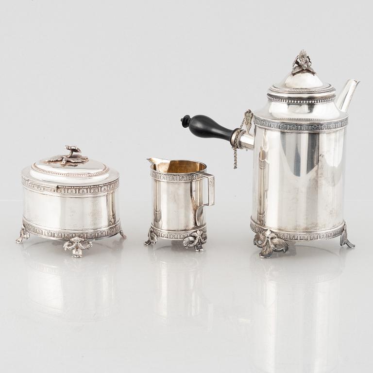 A Swedish Gustavian style silver coffee pot, cream jug and sugar box, mark of CG Hallberg, Stockholm 1897-98.