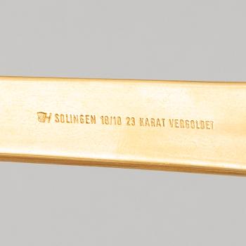 A 107-piece 23/24K gilded stainless steel flat wear set, mostly te same model, Solingen, Germany.