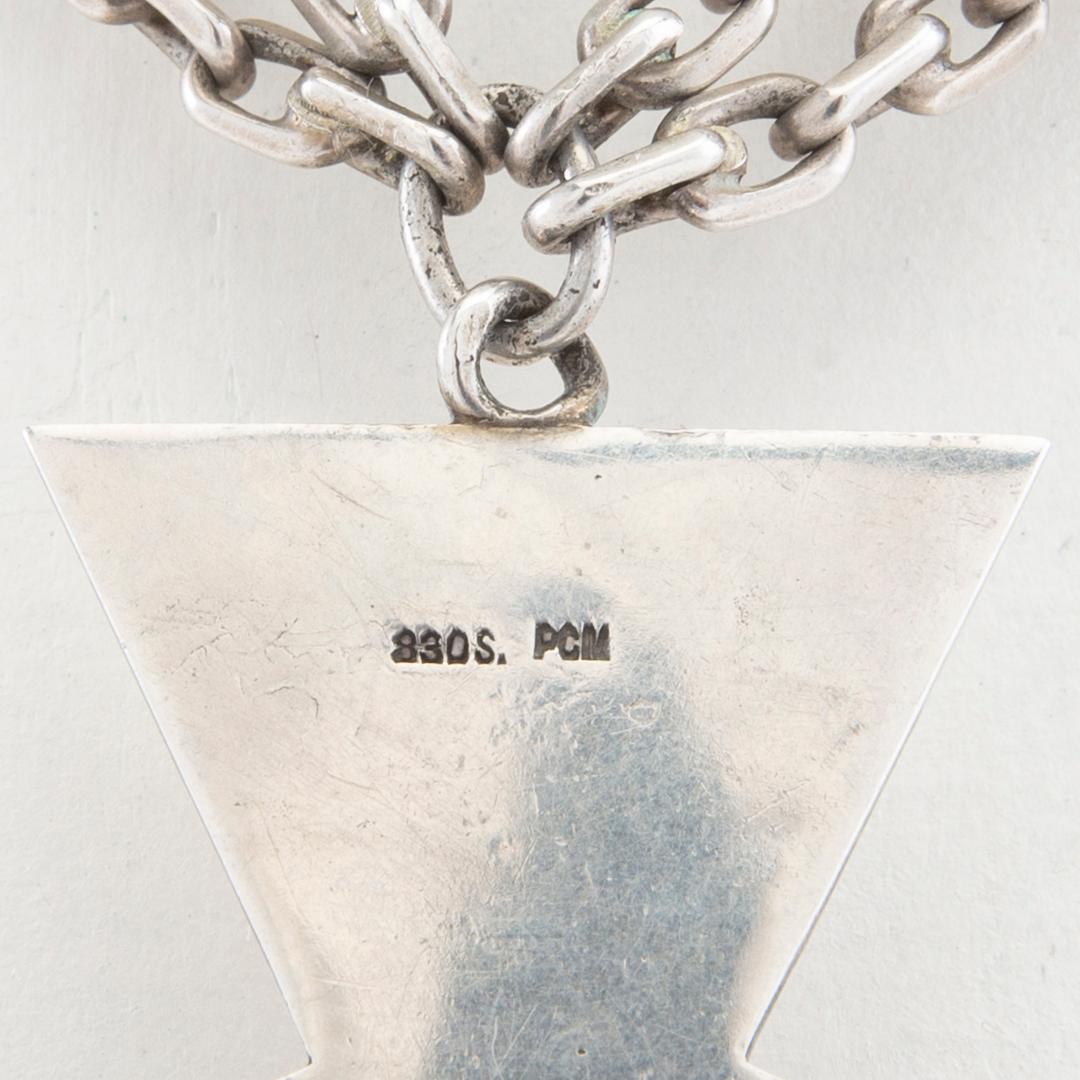 Halsband av silver i form av ett kors med fasetterat glas.