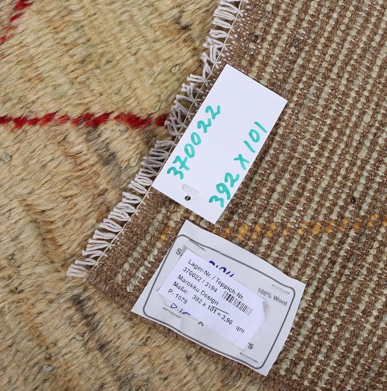 A Moroccan runner carpet, c. 392 x 101 cm.